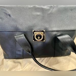 This is an original Ferragamo purse with a small bag inside.
